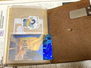 PVC製ジッパーケースの右外側。
カードサイズが横入るポケットが2つ並んでおり上段にステッカー、下段にカードサイズミラーが入っている。